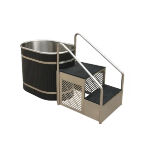 Angled side view of metal tub for ice baths, equipped with sturdy black steps, stainless steel barrel, and handrail