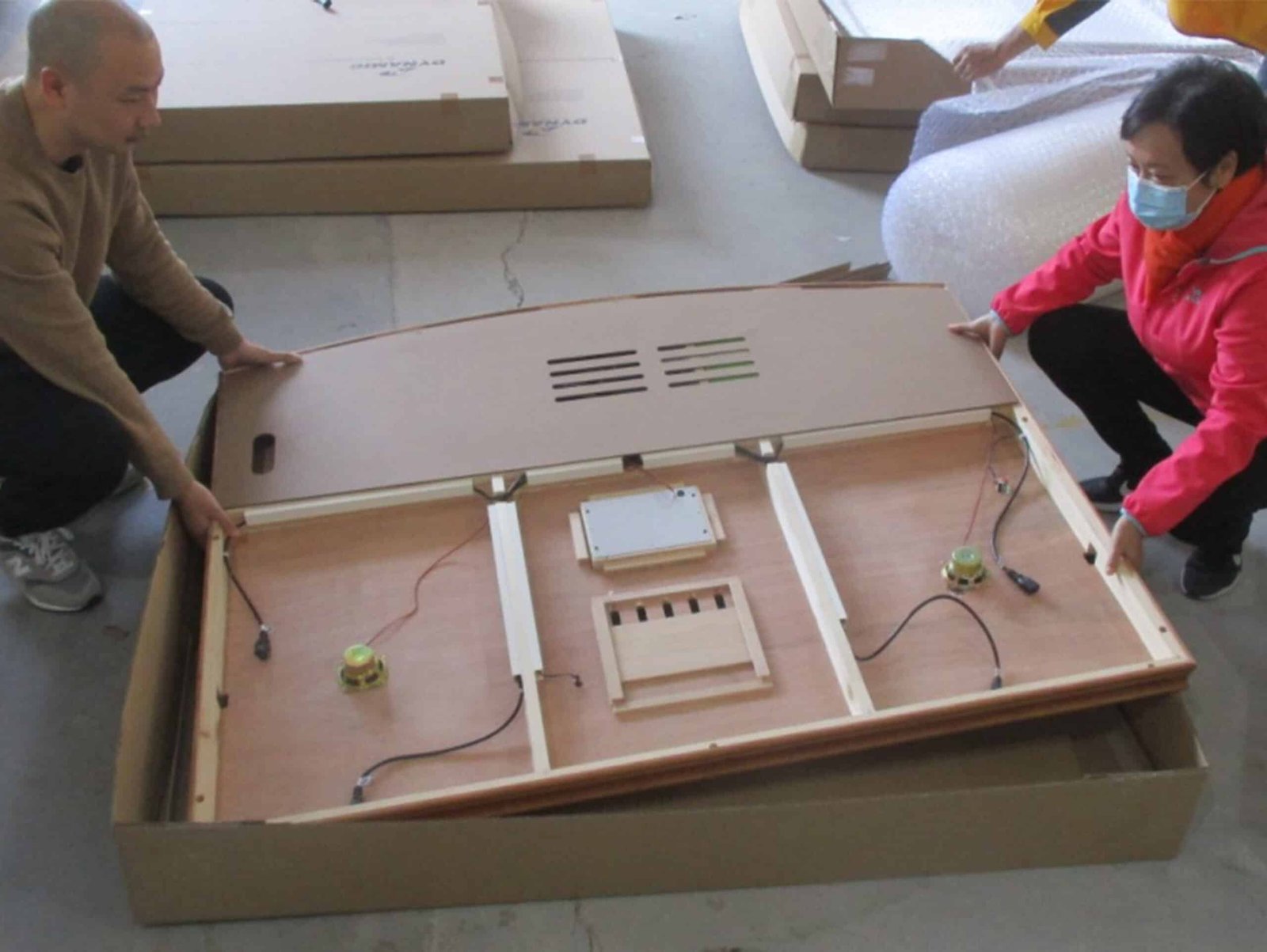 Technician installing electrical controls in a wooden sauna cabin