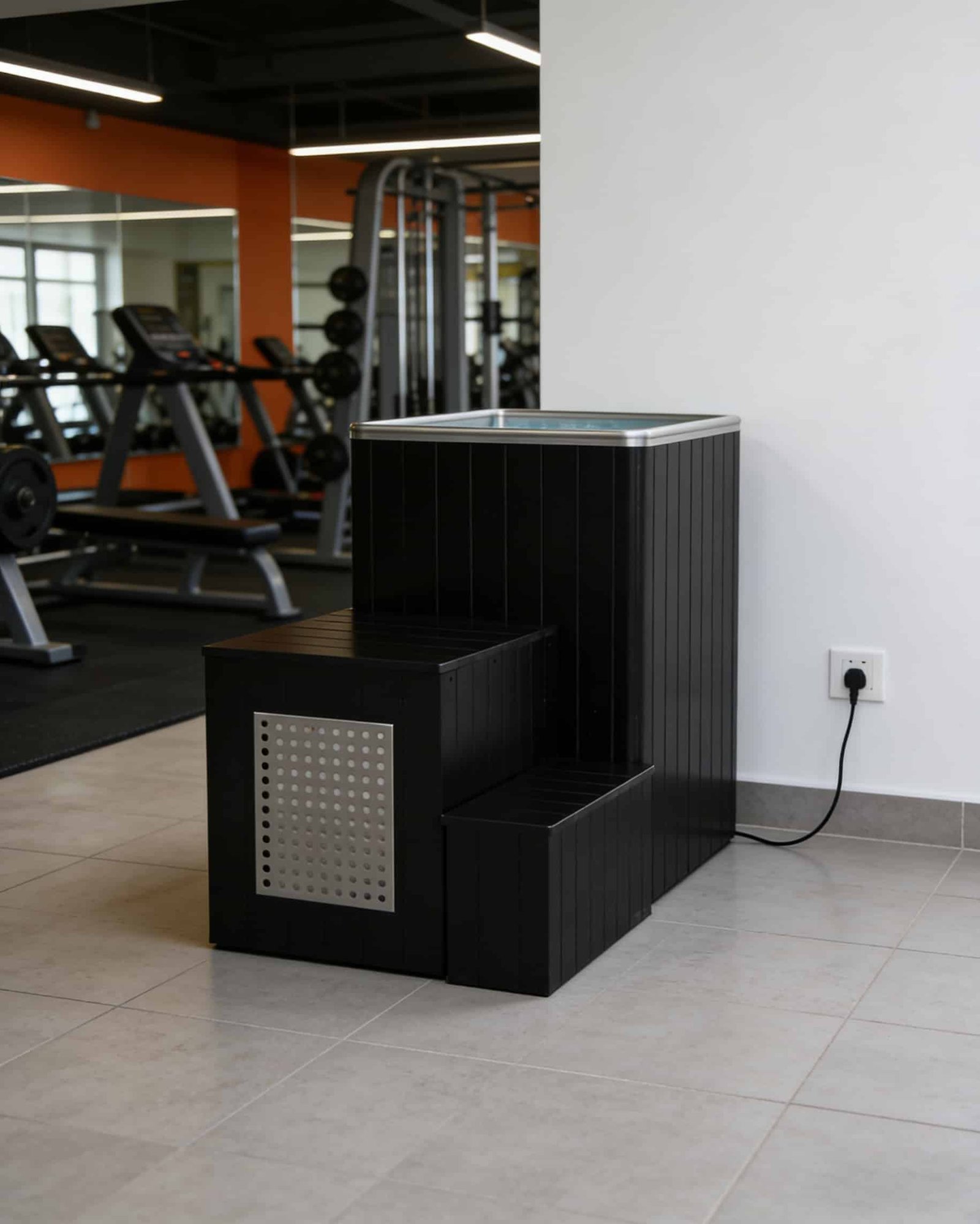 OMNI Ice plug-and-play commercial cold plunge connected to standard power outlet in gym — 30-minute installation with no plumbing required