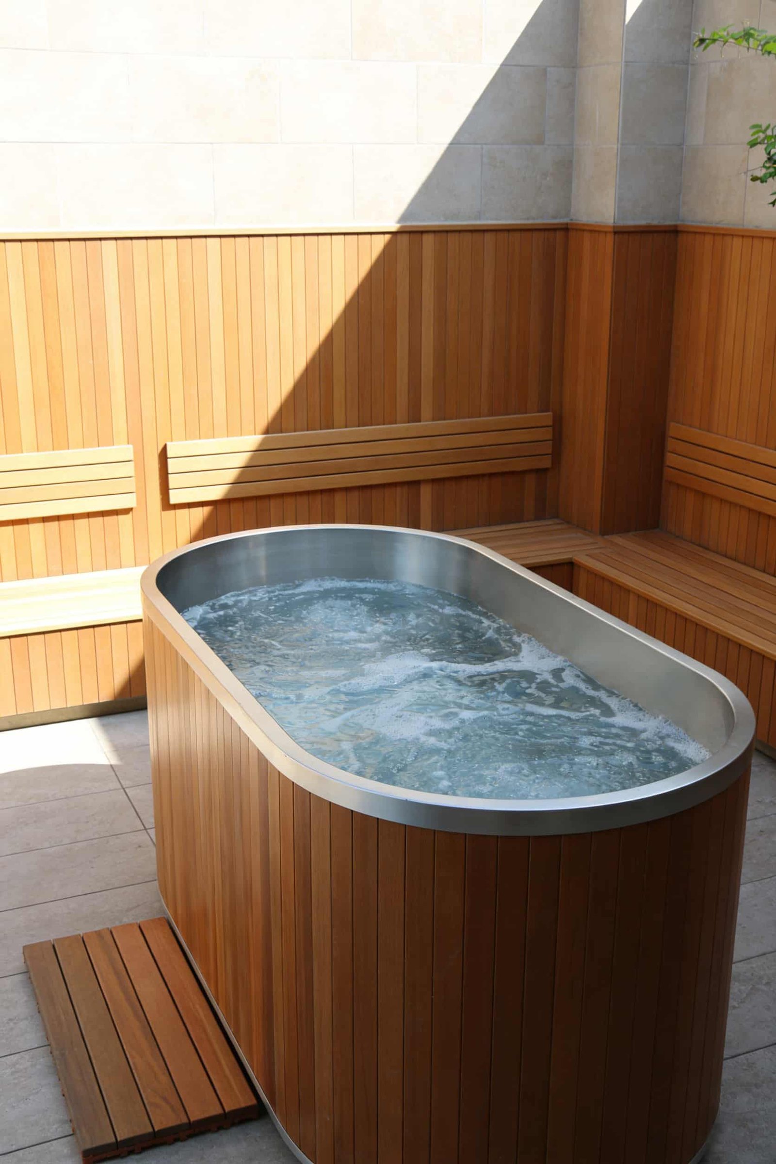 Oval sports recovery ice bath tub with natural wood finish for luxury wellness facilities